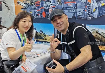 Zenith Crusher representative communicates with overseas client at Canton Fair, presenting crushing plant solutions